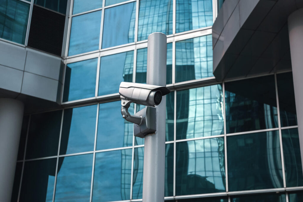 external-surveillance-camera-against-glass-buildin-2023-11-27-05-28-21-utc