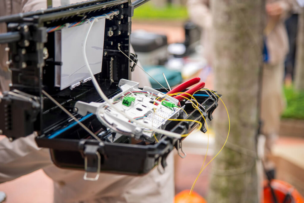 technicians-are-install-cabinet-on-fiber-optic-cab-2023-11-27-05-06-25-utc